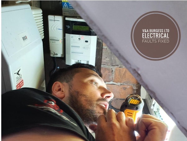 Electrician in a cupboard working on a consumer unit - Electrical Faults Fixed