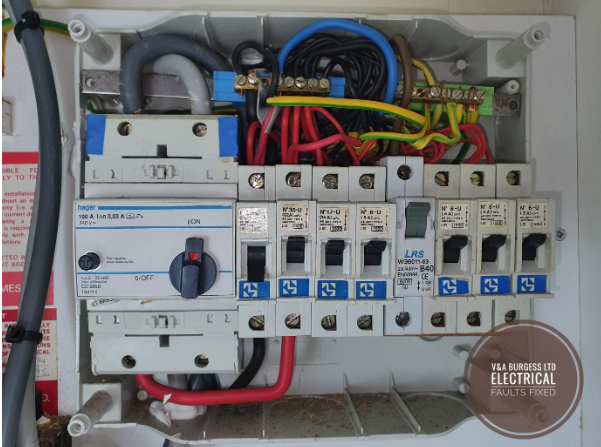 The cover of a consumer unit removed for inspection during an EICR